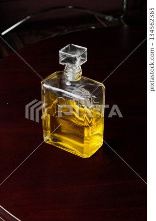 Oldfashioned Amber Glass Bottle Arranged On Mahogany Table With Warm Lighting And Reflective Qualities Oldfashioned Amber Glass Bottle Arranged On Mahogany Table With Warm Lighting And Reflective Qualities 134562365
