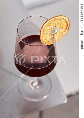 Elegant Drink Presentation, Minimalist Composition Featuring Wine Glass With Dried Orange Accent 134562394