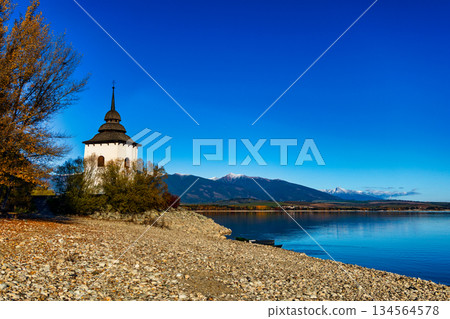 Old church tower of Havranok by Liptovska Mara lake with Tatra mountains in autumn Old church tower of Havranok by Liptovska Mara lake with Tatra mountains in autumn 134564578