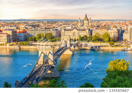 Skyline panorama of Budapest Chain Bridge over blue Danube with St. Stephen's basilica view, Hungary Skyline panorama of Budapest Chain Bridge over blue Danube with St. Stephen's basilica view, Hungary 134565667