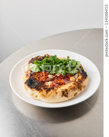 Authentic Neapolitan style pizza with melted cheese and smoky flavor 134566453