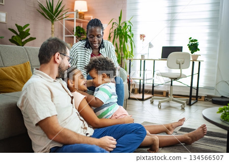 Laughter and bonding among family members in a warm room 134566507