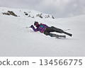Skiing in the winter woman fallen over 134566775