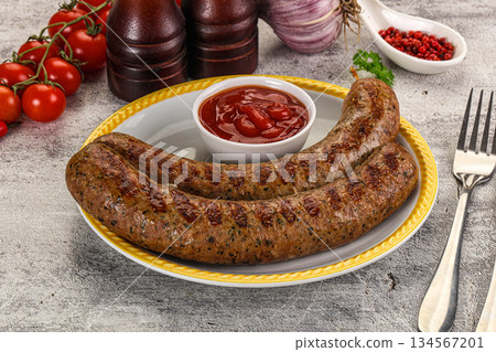 Grilled beef sausages with sauce 134567201