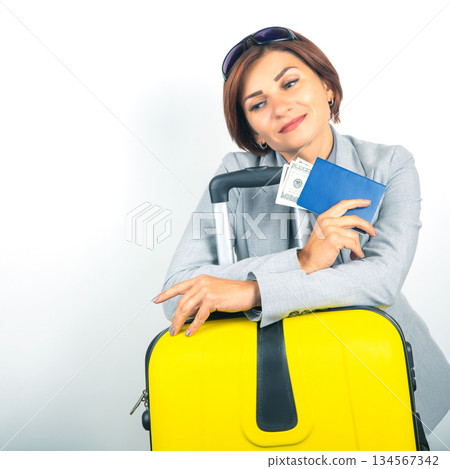 Happy beautiful business woman with passport and baggage going on a trip 134567342