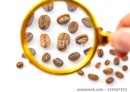 Golden magnifying glass with a red handle placed on a white background 134567352