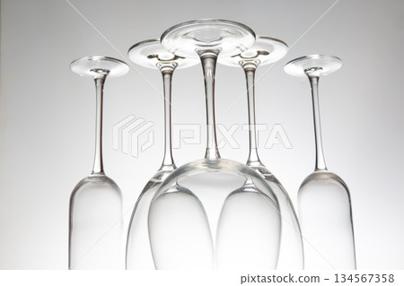 A stylish collection of five empty wine glasses with distinct designs 134567358