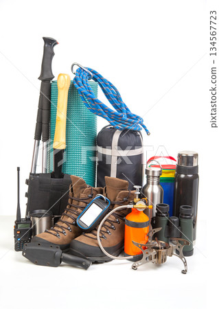 Outdoor adventure gear assortment including hiking boots, camping equipment, and safety tools Outdoor adventure gear assortment including hiking boots, camping equipment, and safety tools 134567723