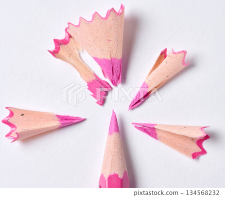 Wooden shavings and pink pencil on white background, top view Wooden shavings and pink pencil on white background, top view 134568232