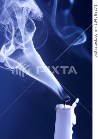 Smoke extinguished candle on a dark background. The concept of spirituality and the end of life. 134568271