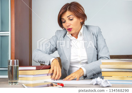 Business woman tired in the office and worried in emotions. Stress and headache 134568290