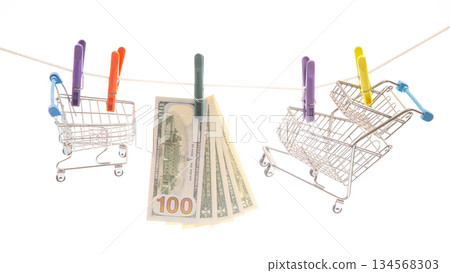 toy shopping carts secured with colorful clothespins on a line 134568303