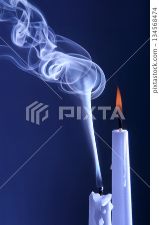 Smoke extinguished candle on a dark background. The concept of spirituality and the end of life. 134568474