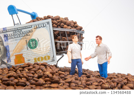 A playful scene with miniature people on a bed of coffee beans, a shopping cart brimming with beans A playful scene with miniature people on a bed of coffee beans, a shopping cart brimming with beans 134568488