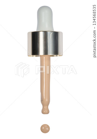 Glass pipette with a drop of foundation on an isolated background Glass pipette with a drop of foundation on an isolated background 134568535