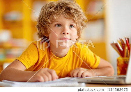 Boy focused on homework in a bright cozy study space with colorful shelves Boy focused on homework in a bright cozy study space with colorful shelves 134568675