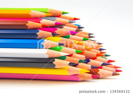 Brightly colored pencils in a wavy row against a white surface 134569132