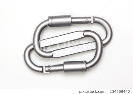 two united grey climbing carabiner on a white background 134569440