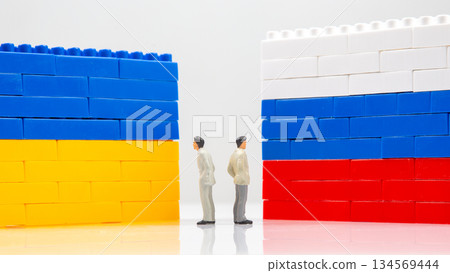 A creative scene with two blocks walls resembling the Ukrainian and Russian flags 134569444