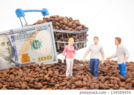 Innovative photo with miniature figures on coffee beans, a shopping cart filled with beans 134569454