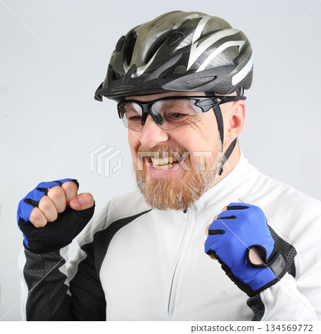 Cyclist celebrating after completing a challenging ride in a vibrant cycling outfit 134569772