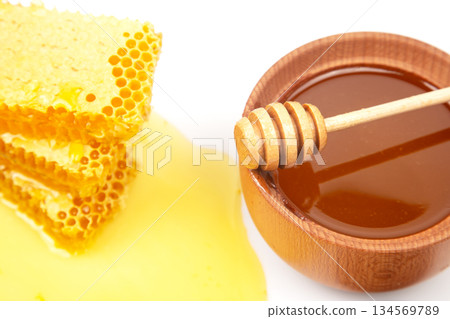 Honeycomb and honey in bowl presented in a simple and fresh arrangement 134569789