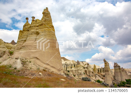 Majestic rock formations in Cappadocia, Turkey under a cloudy sky during midday Majestic rock formations in Cappadocia, Turkey under a cloudy sky during midday 134570005
