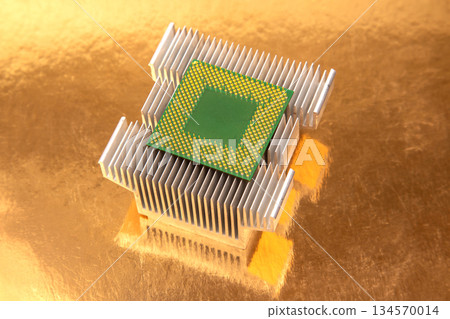 Close-up of a computer processor on a heatsink with a gold reflective backdrop 134570014