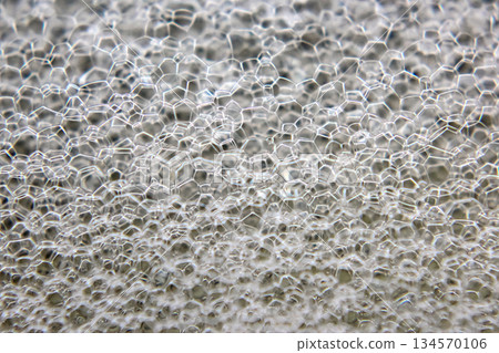 Close-up view of intricate soap bubbles forming a stunning hexagonal pattern Close-up view of intricate soap bubbles forming a stunning hexagonal pattern 134570106