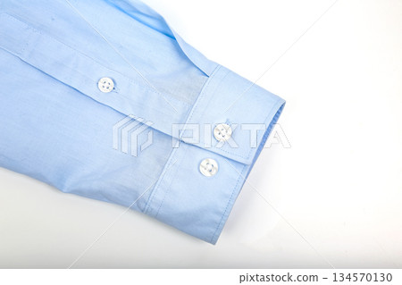 Light blue dress shirt sleeve with buttons on a white background for fashion Light blue dress shirt sleeve with buttons on a white background for fashion 134570130
