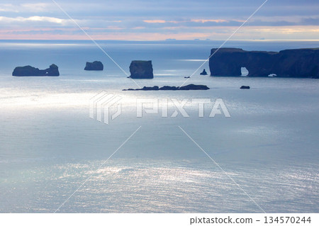 Natural rock formations against the ocean backdrop in southern Iceland under soft daylight 134570244