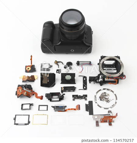 Camera disassembled with various internal components arranged for display and analysis 134570257