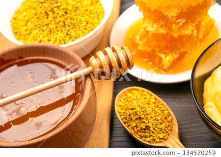 Honey and bee products displayed together in a rustic setting for culinary inspiration Honey and bee products displayed together in a rustic setting for culinary inspiration 134570259