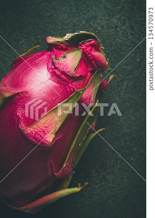 Dragon fruit, pitahaya, one piece, top view, rustic style, green background, 134570973
