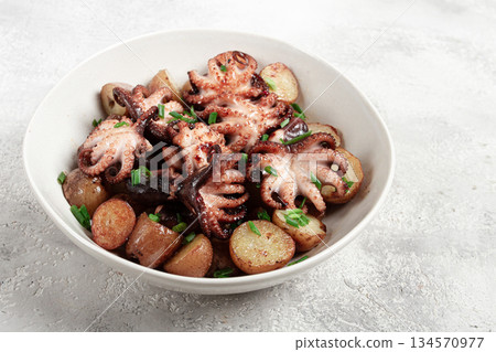 baby grilled octopus with golden baked potatoes and fresh herbs, Maltese cuisine, homemade, no people, 134570977