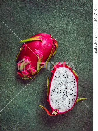 Dragon fruit, pitahaya, one piece, cut, top view, rustic style, green background, Dragon fruit, pitahaya, one piece, cut, top view, rustic style, green background, 134571003
