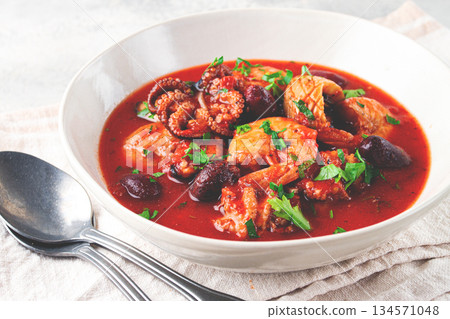 seafood assortment in tomato sauce, olives, in a white plate, seafood assortment in tomato sauce, olives, in a white plate, 134571048