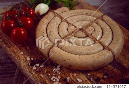 raw spiral sausages, on a wooden board, top view, no people, 134571057