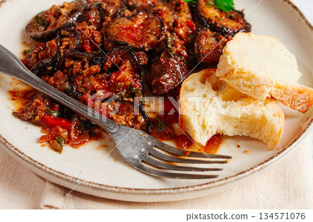 stewed meat with eggplant is a Georgian dish, on a light background,homemade, no people stewed meat with eggplant is a Georgian dish, on a light background,homemade, no people 134571076