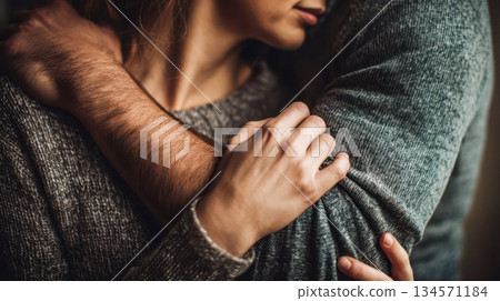 An intimate embrace of a loving couple holding hands, warm relations, trust, and emotional connection 134571184