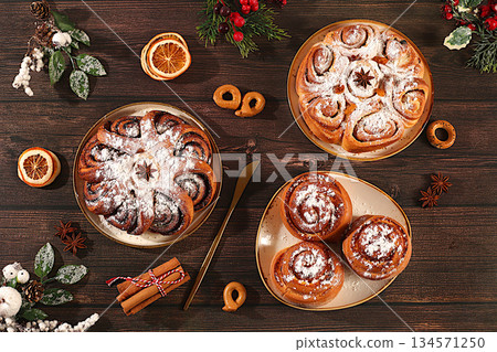 Homemade winter desserts, stollen, rolls, pies, or buns with nuts, cinnamon, cranberries, poppy seeds, and egg liqueur. Festive kitchen banner. Concept for holiday baking, seasonal treats, 134571250