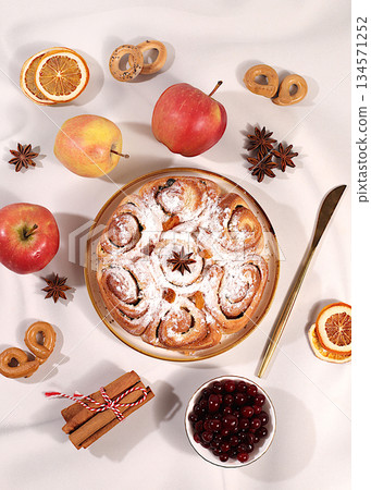 Apple pies and cupcakes with nuts, cinnamon, poppy seeds, cranberries, and egg liqueur.Homemade winter dessert,Festive kitchen banner. The concept of festive pastries, Apple pies and cupcakes with nuts, cinnamon, poppy seeds, cranberries, and egg liqueur.Homemade winter dessert,Festive kitchen banner. The concept of festive pastries, 134571252