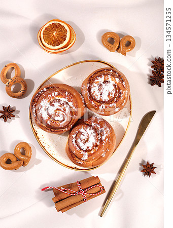 Buns or muffins with nuts, cinnamon, poppy seeds, and egg liqueur.Festive kitchen banner. The concept of festive pastries, seasonal treats and cafe advertisements, restaurant menus. Homemade dessert, Buns or muffins with nuts, cinnamon, poppy seeds, and egg liqueur.Festive kitchen banner. The concept of festive pastries, seasonal treats and cafe advertisements, restaurant menus. Homemade dessert, 134571255
