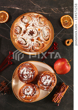 Apple pies, buns, cupcakes with apples, cinnamon, poppy seeds, cranberries, and egg liqueur.Homemade winter dessert,Festive kitchen banner. The concept of festive pastries, seasonal treats 134571258