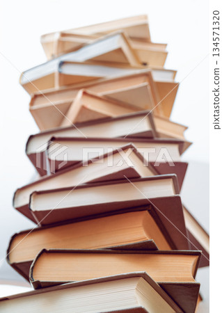Stack of books in library. Scientific, educational, and fiction paper books. Education and training. 134571320