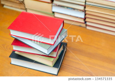 Stack of books in the library. Symbol of knowledge and learning. Stack of books in the library. Symbol of knowledge and learning. 134571335
