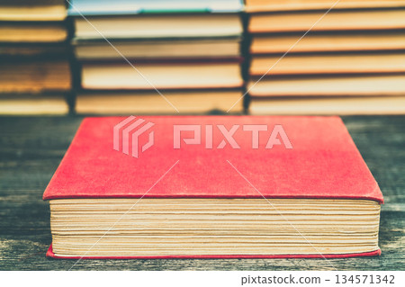 Old book in the red obnozhka. Symbol of knowledge and learning. Old book in the red obnozhka. Symbol of knowledge and learning. 134571342