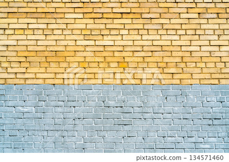 Wall of yellow and gray bricks. Abstract architectural background. 134571460