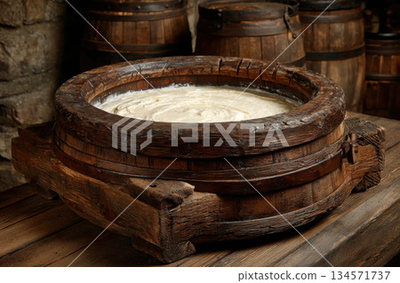 Traditional butter churn creating fresh creamy butter Traditional butter churn creating fresh creamy butter 134571737