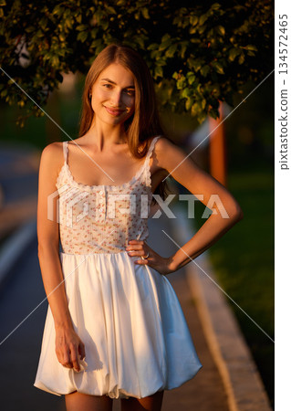 Slavic Woman in Sunlit Garden Wearing White Skirt Slavic Woman in Sunlit Garden Wearing White Skirt 134572465